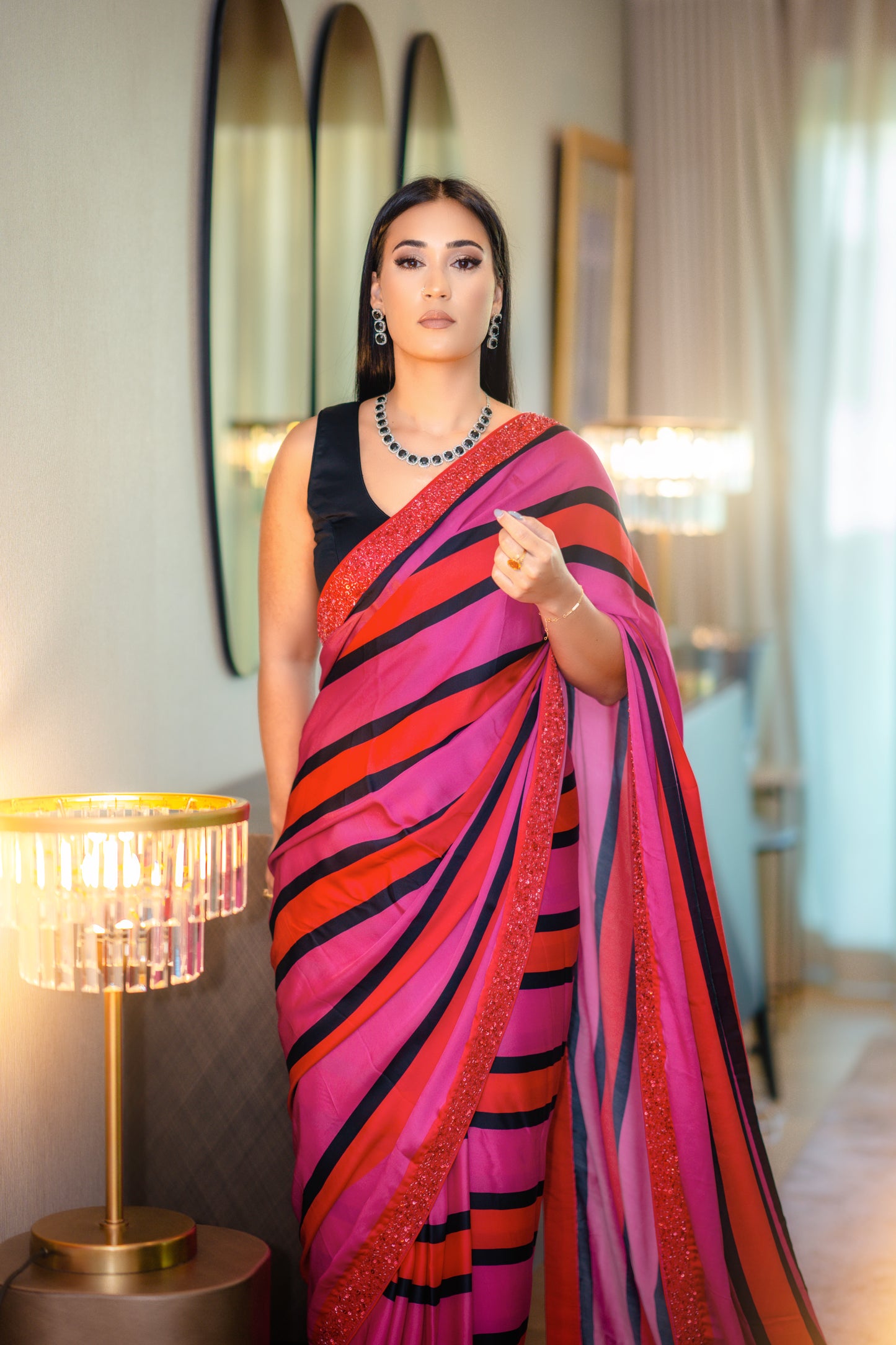 Silk striped saree with beaded border and black semi stitched velvet blouse