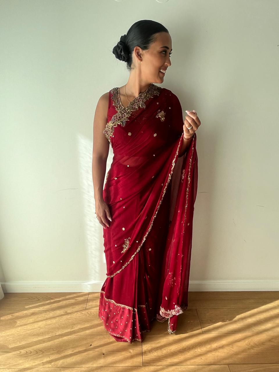 Maroon chiffon saree with gold cutwork border